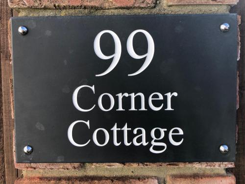 a sign on the side of a brick building at Corner Cottage - character, charm, great location. in Ringwood