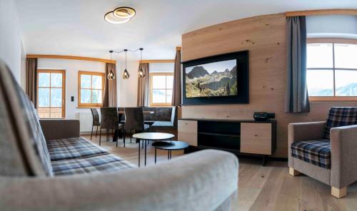 ナウダースにあるROSENHOF- Premium & Landhaus Apartments & Wellness & Erlebnisbauernhofのリビングルーム(ソファ、テレビ付)