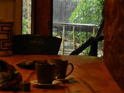 a table with two cups of coffee on it at EcoRoundHouse in Filandia