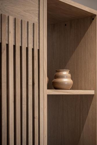 a wooden shelf with a vase sitting on it at Esperides Beach Hotel Apartments in Stalos