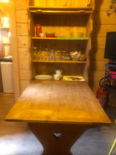 a wooden shelf with dishes on it in a kitchen at Chalet Dufour in Morzine