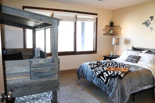1 dormitorio con cama de madera y ventana grande en Stay & Play in the Little Switzerland of Utah!!! en Draper