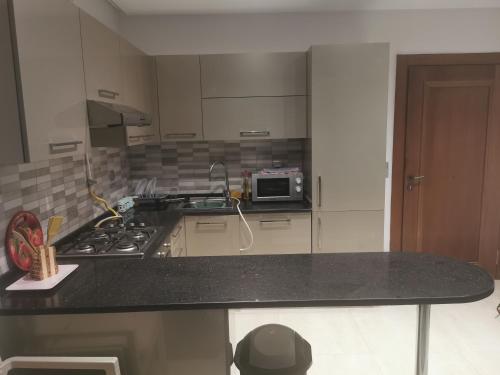 a kitchen with a stove and a counter top at Palm Lake Resort (FOLLA) Sousse-Monastir in Monastir