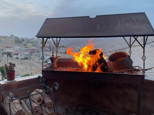 a grill with pots and pans on fire at Petra Desert Dream Hotel in Wadi Musa