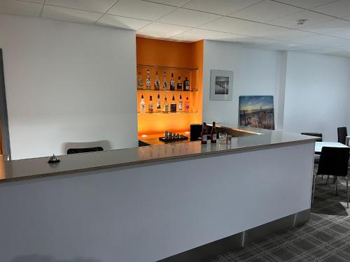a bar in an office with a counter and chairs at OYO Wave Crest Hotel in Blackpool
