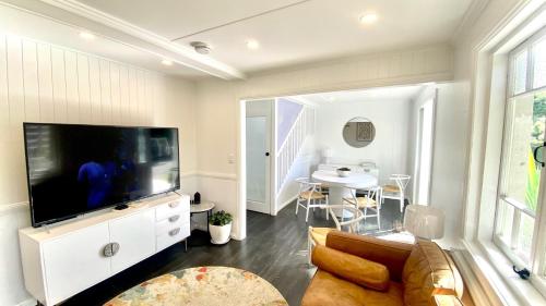 a living room with a large flat screen tv at Urban Getaway Apartment Ipswich in Ipswich