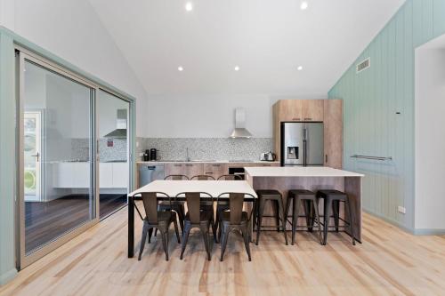 a kitchen with a table and chairs in a room at Shelly Beach Holiday Home in Shelly Beach