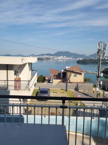 a view of a body of water from a balcony at Yeosu Blooming Pension in Yeosu