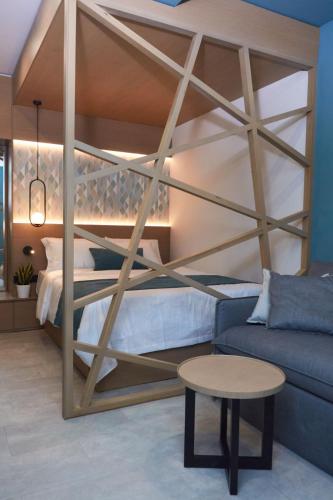 a bedroom with a bunk bed and a couch at 7Rizes Luxury Living in Heraklio Town