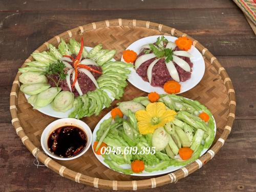 a plate of food with vegetables on a table at BenTrestay in Giồng Tú Ðiền