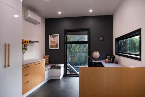 a home office with a desk and a window at East St Spa House in Daylesford
