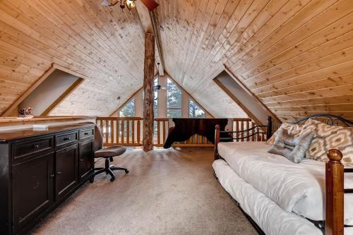 a bedroom with a bed and a desk in a attic at Amazing Private Luxury Home with Stunning Panoramic Views - The Timbers at Glacier Ridge in Fairplay