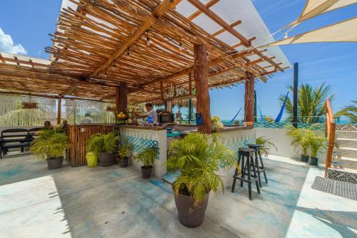 a bar on a patio with potted plants at Hotel Villas Tiburon Adults Only in Holbox Island