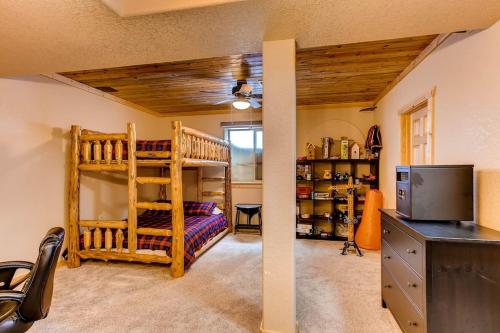 a room with a bunk bed and a tv in a room at Immaculate & Private Mountain Home with Hot Tub - Sugar Pine Lodge in Fairplay