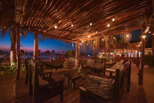 a patio with couches and chairs and a table at Hotel Villas Tiburon Adults Only in Holbox Island