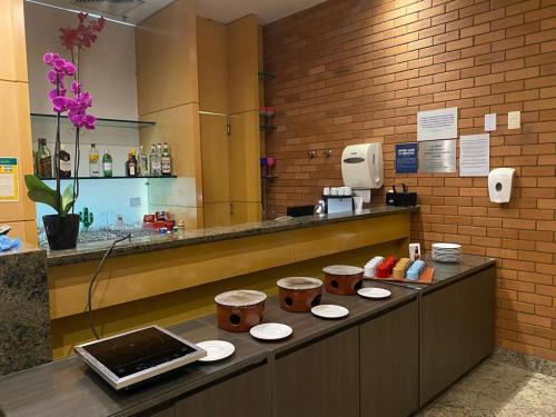 a kitchen with a counter with stools on it at Botafogo Suites in Rio de Janeiro