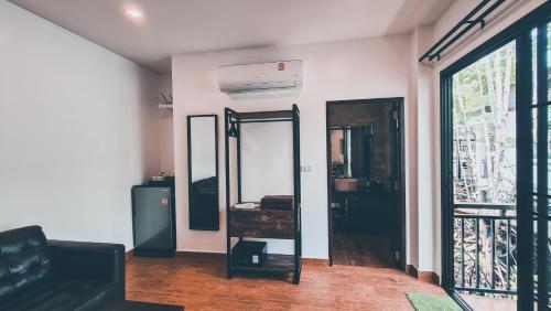 a dressing room with a mirror and a window at Baan Rim Nam in Ko Chang