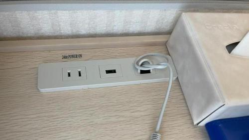 an electronic device with a cord plugged into a box at Toyoko Inn Yokohama Sakuragicho in Yokohama