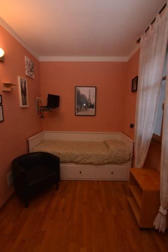 a bedroom with a bed and a chair in it at Albergo Casa Al Sole in Greve in Chianti