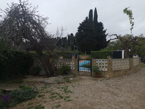 a fence with a gate in a yard at Casa Rural Masia d'en Gall in L'Aldea