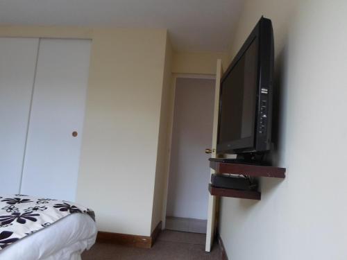 a bedroom with a flat screen tv on a wall at Nautel in Bahia Inglesa