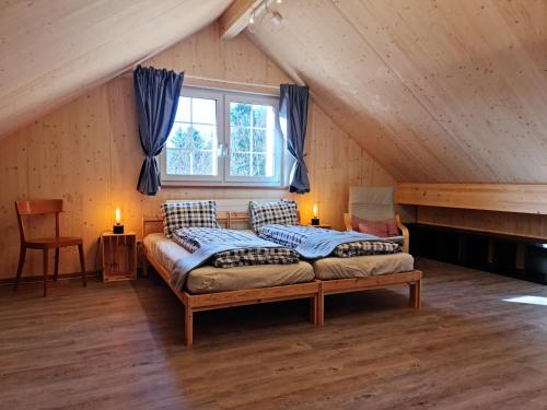 a bedroom with two beds in a attic at Grosses Ferienhaus für traumhafte Familienferien im Appenzellerland in Speicher