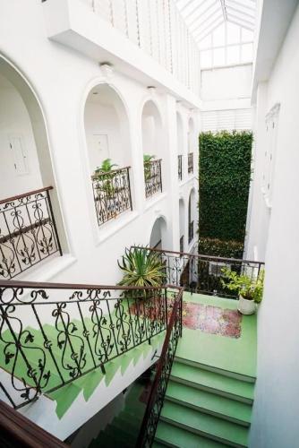 a staircase in a building with plants on the walls at Casa Blanca Boutique Hotel - SHA Plus in Phuket Town
