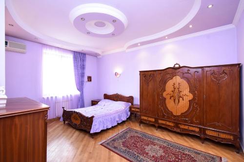 a bedroom with a large wooden bed in a room at Guest house YEREVAN in Yerevan