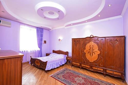 a bedroom with a large wooden bed in a room at Guest house YEREVAN in Yerevan