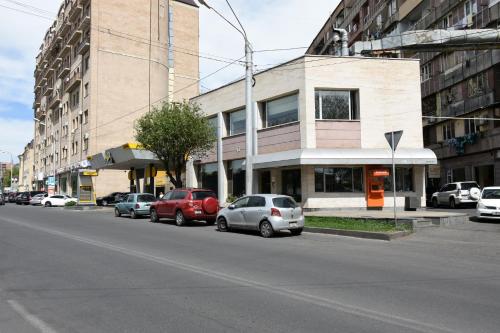 a row of cars parked on the side of a city street at Guest house YEREVAN in Yerevan