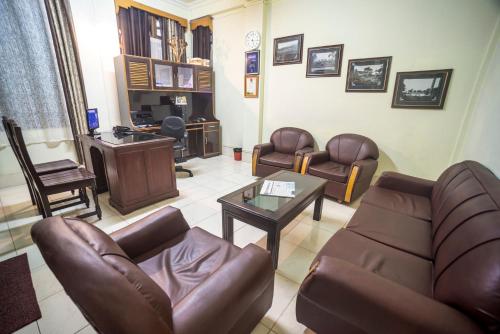 a living room with a couch and a table at Apsara Guest House in Shillong