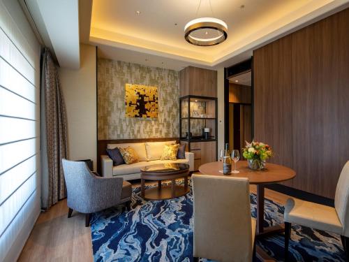 a living room with a couch and a table at Hotel Monterey Edelhof Sapporo in Sapporo