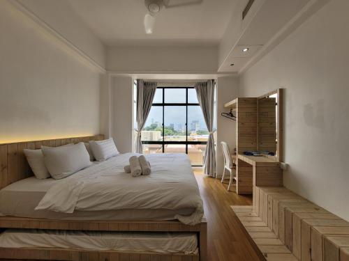 a bedroom with a large bed and a window at Mahkota by The Bliss Malacca in Malacca