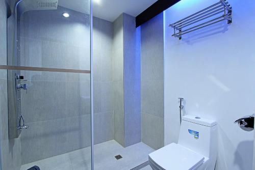 a bathroom with a glass shower with a toilet at Bergamo Hotel in Lingayen