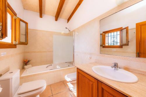 a bathroom with a sink and a toilet and a tub at Son Peris in Caʼs Concos