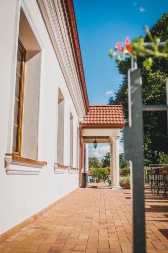 a hallway of a white building with a porch at Pod Kolumnami in Pilica