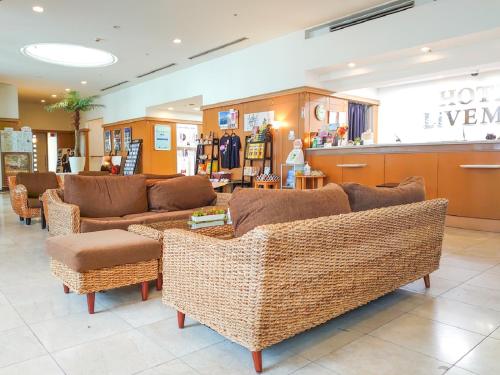 a store with couches and chairs in a store at HOTEL LiVEMAX BUDGET Kagoshima in Kagoshima