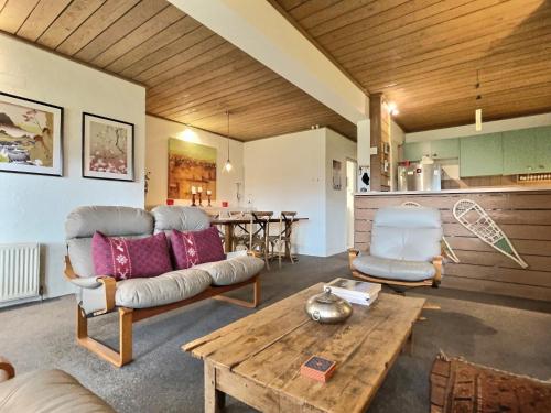 a living room with a couch and a table at Snow Gums Apartment 4, alpine-getaways in Dinner Plain
