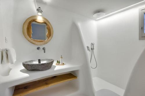 a bathroom with a sink and a mirror at Beachfront Villa Kalafatis by Aesthia Estate in Kalafatis