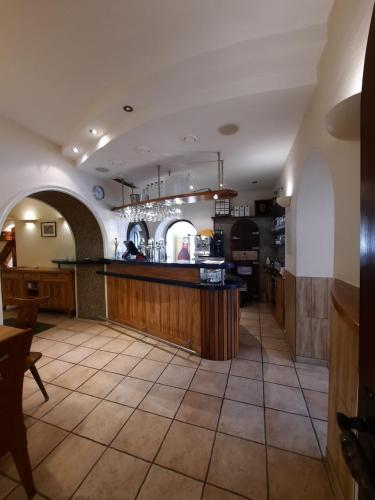 a large kitchen with a bar in a restaurant at Gasthof Sauer GmbH in Straß in Steiermark