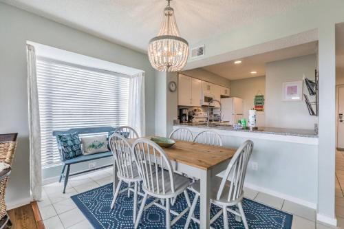 a kitchen and dining room with a wooden table and chairs at Harbor Island M118 in Oceanmarsh Subdivision