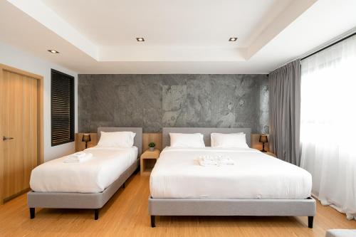 Cama o camas de una habitación en โรงแรมอินฟินิทเกษตร