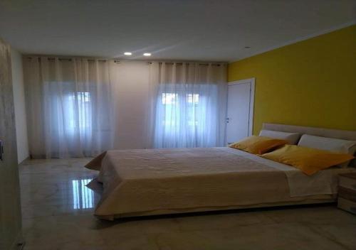 Кровать или кровати в номере Locazione turistica Totaro