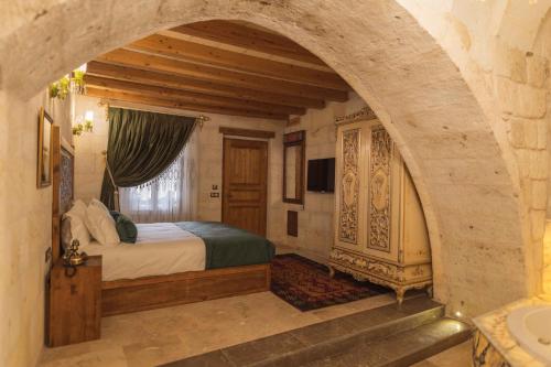 a bedroom with an archway with a bed in it at Solo Cave Suites in Nevsehir