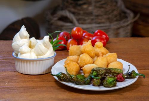 a plate of food with vegetables on a table at Agriturismo Masseria Cannella in Lesina