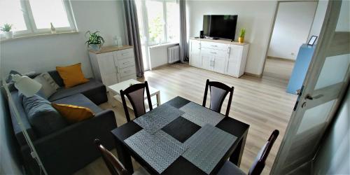 a living room with a table and a couch at M&M Suwałki Centrum in Suwałki