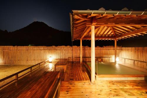 a wooden pavilion with benches in the night at Fujiya in Niigata