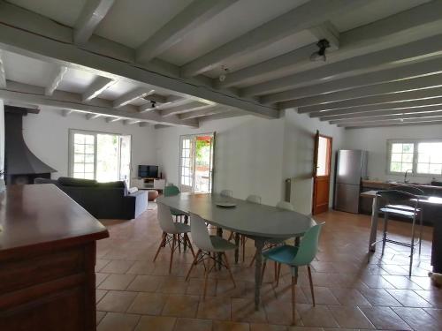 a kitchen and living room with a table and chairs at Baketsua in Saint-Pée-sur-Nivelle