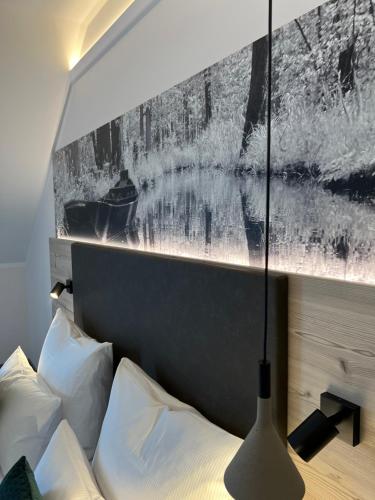 a bedroom with a bed with a picture on the wall at Landhotel Burg im Spreewald - Resort & Spa in Burg