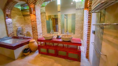 a bathroom with two sinks and a large mirror at Bali Dyana Villas in Seminyak